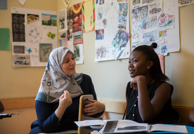 RYSA teacher works with an upper school student in class.