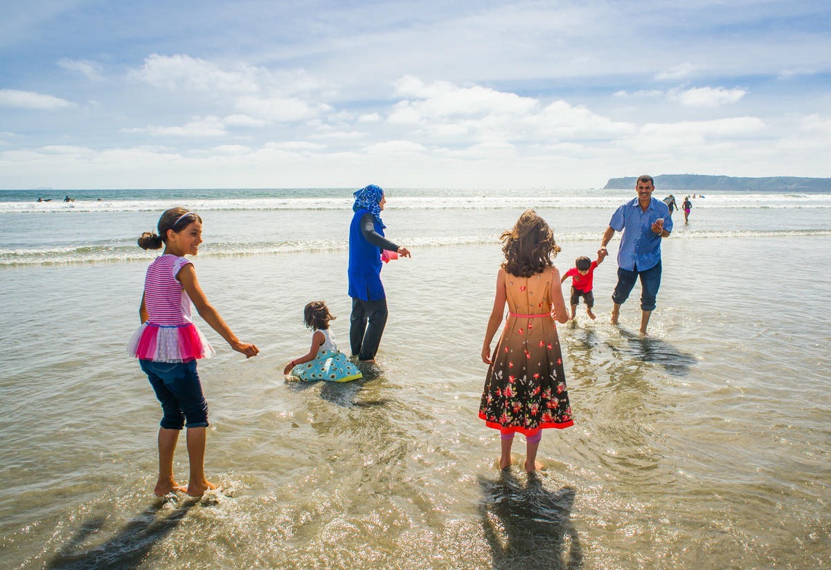 Azzam and Nisreen Tlas and their children play in the surf on a California beach Azzam and Nisreen Tlas and their children play in the surf on a California beach