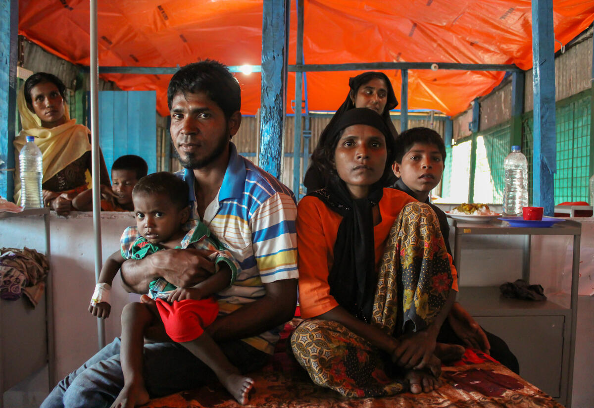 Rohingya refugees who fled to Cox's Bazar, Bangladesh are at risk of malnutrition and disease without sufficient food, health care and medication. A Rohingya refugee family at an IRC-supported health Facility in Cox's Bazar, Bangladesh.