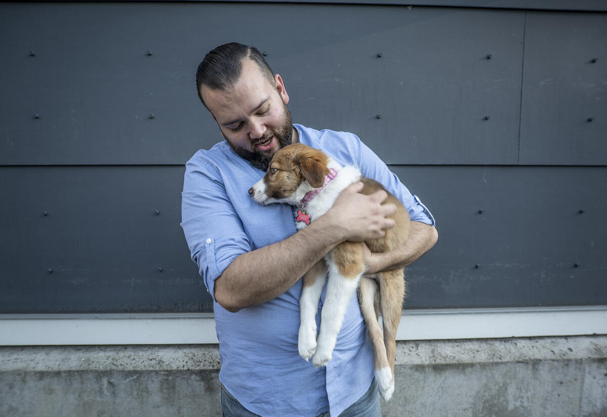 Suamhirs with his puppy, Lilly. Suamhirs holds his puppy, Lilly.