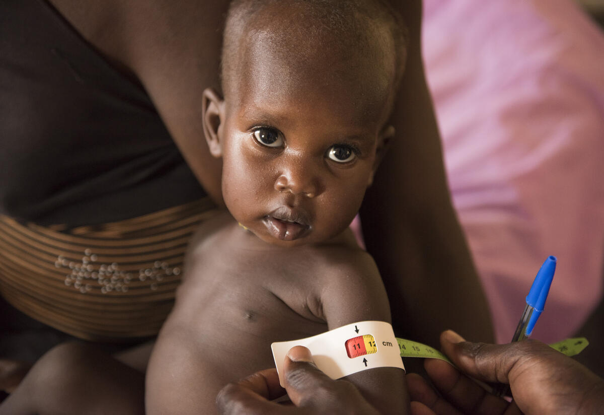 A child's arm is measured by health workers at an IRC malnutrition center in South Sudan A child has their measurements taken in IRC's malnutrition stabilization center in Panthou, South Sudan.