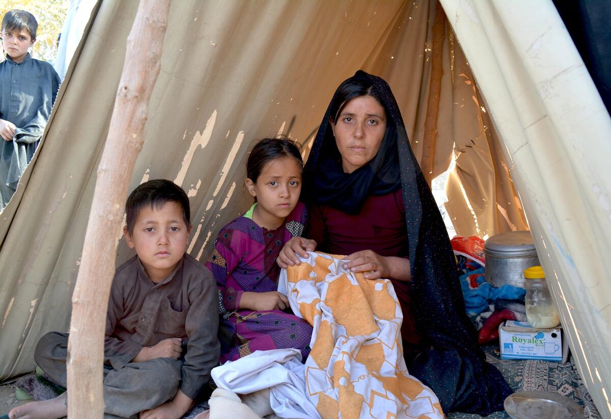 Zainab, 23, a widowed mother of two children, was displaced from her home by the recent drought in Ghor Province, Afghanistan. She lost her husband in an accident two years ago. Zainab, 23, in a tent with her two children