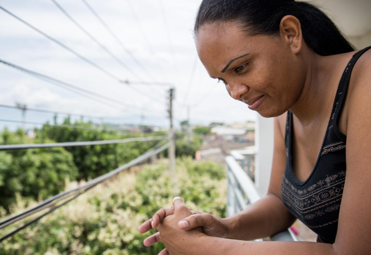Cibel Ortiz looks out over a balcony in Cúcuta, Colombia.