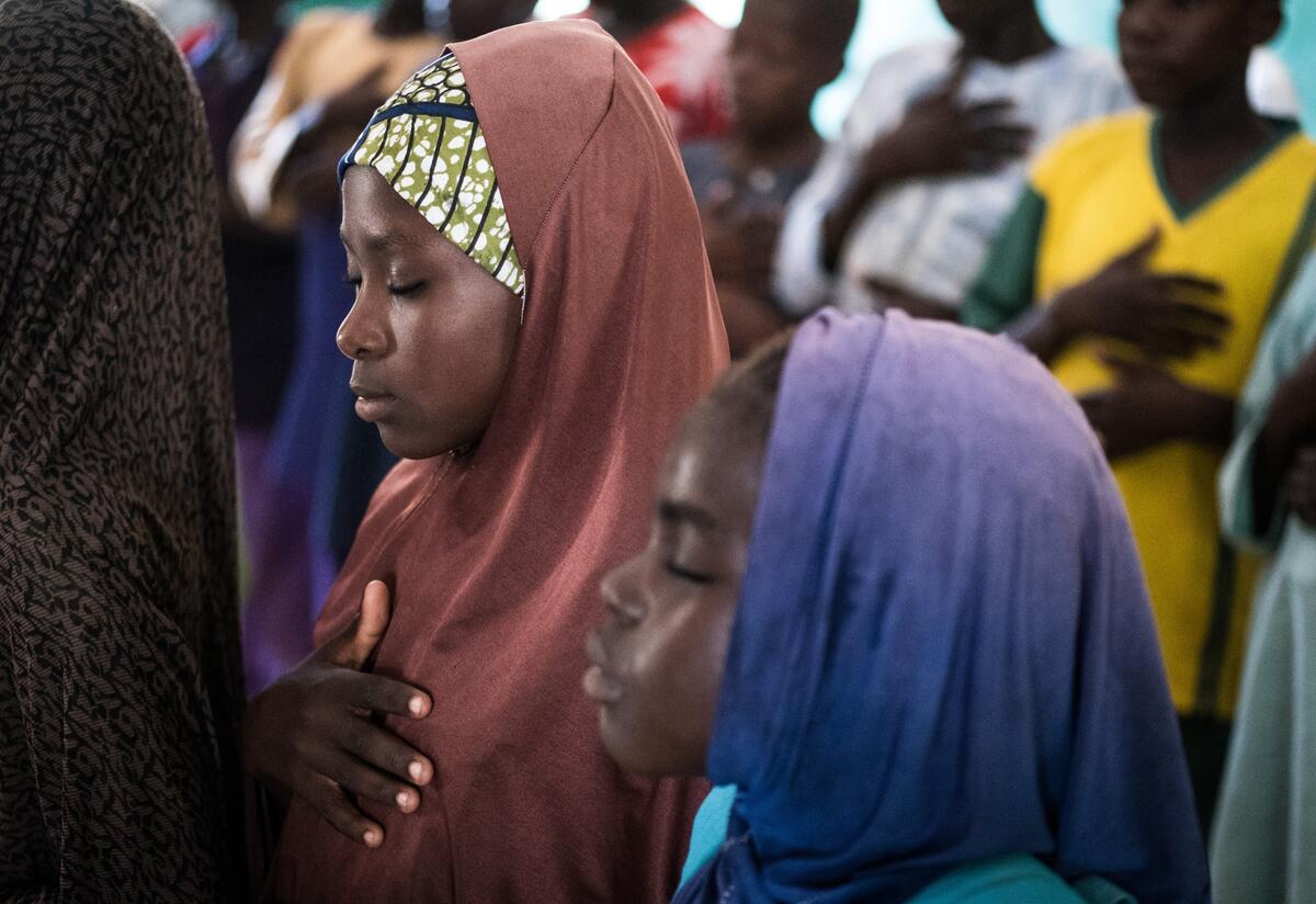 Two girls practice deep breathing techniques in their classroom at at an International Rescue Committee supported school in Nigeria.