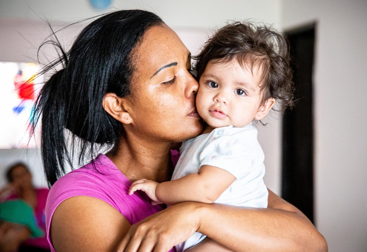 Cibel Ortiz kisses her baby daughter Diana, named after an IRC nurse
