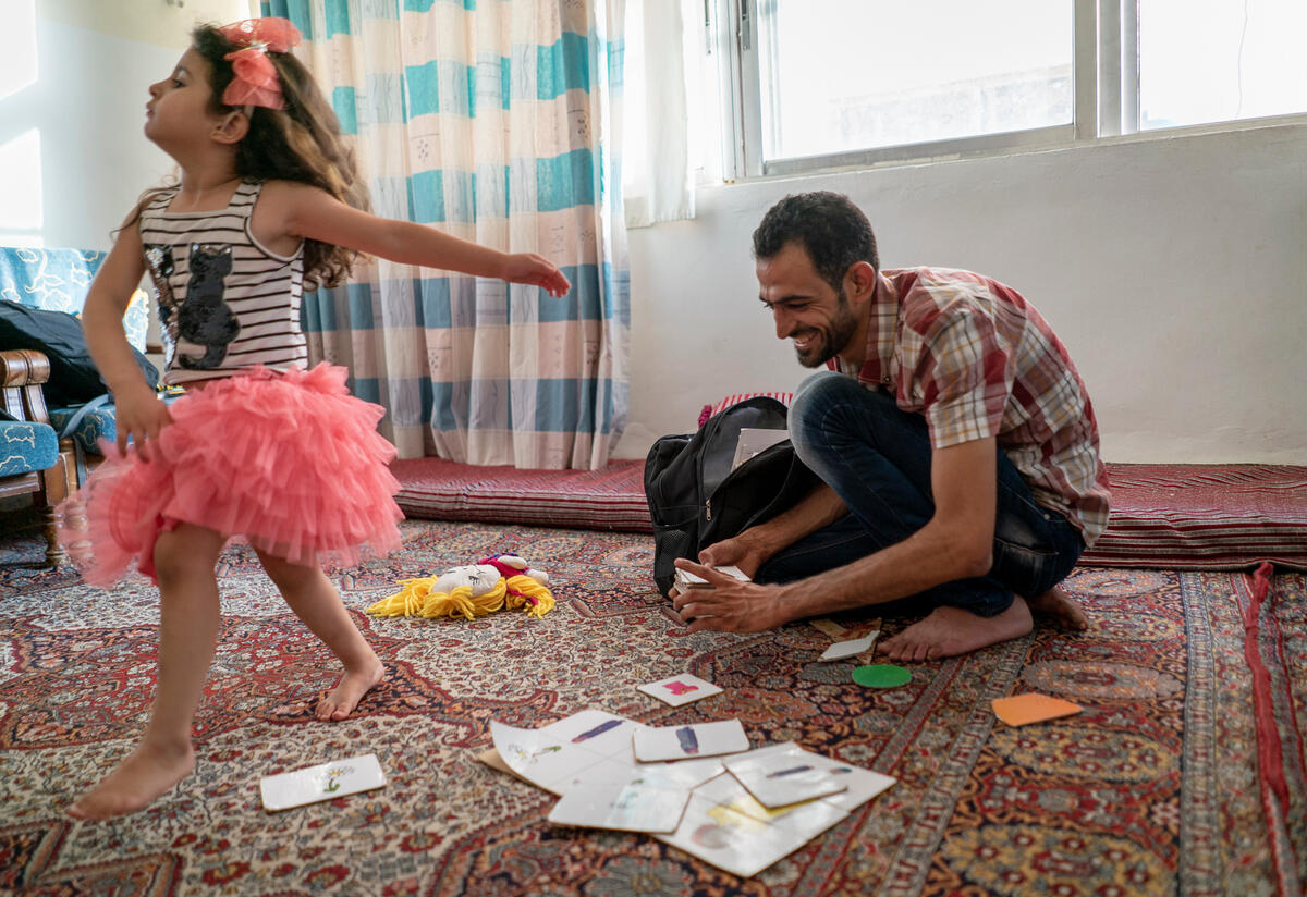 International Rescue Commitee volunteer and Syrian refugee Anas plays with his daughter at home. Anas, an IRC Reach Up & Learn volunteer and Syrian refugee, plays with his daughter Maria, 4 years old, at their home in Mafraq Jordan.