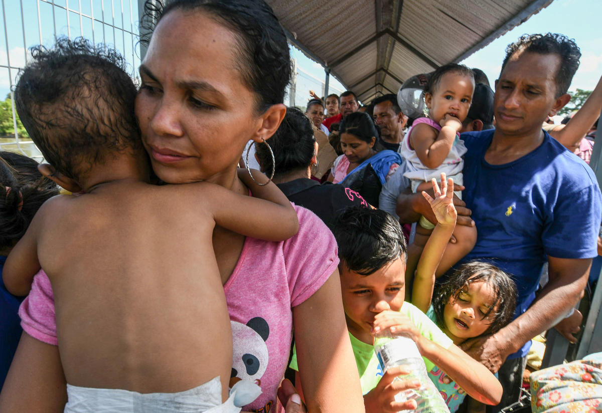 A Honduran migrant couple and their five kids taking part in a caravan heading to the U.S., wait to cross the border from Guatemala to Mexico A Honduran migrant couple and their five kids taking part in a caravan heading to the U.S., wait to cross the border from Guatemala to Mexico