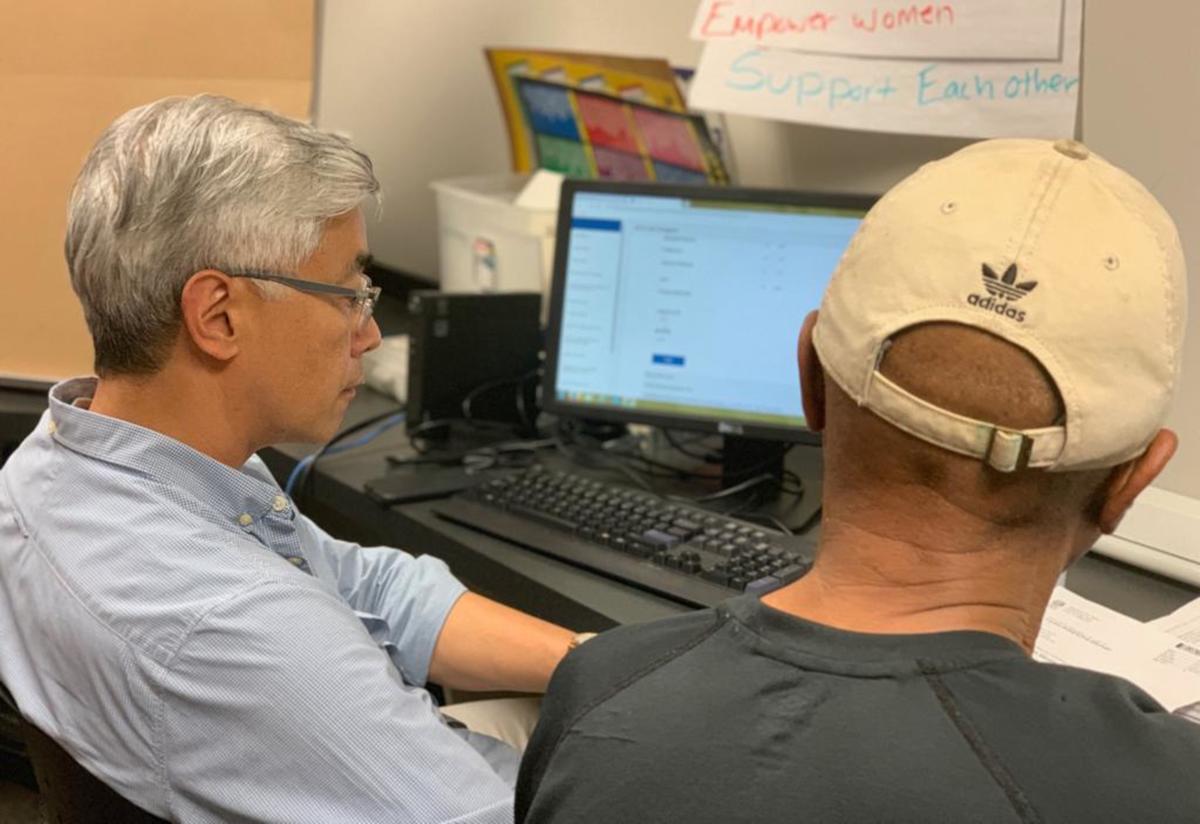 One of our dedicated VITA volunteers assists a client in filing their return.