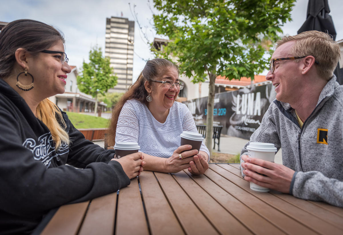 Salvadoran mom and daughter with IRC staff member in San Jose