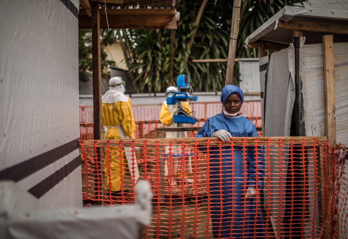 Ebola survivor Kahindo Kamala works at the International Rescue Committee-supported Ebola Treatment Center at Beni Hospital, Congo. An Ebola survivor wears scrubs at an IRC-supported Ebola Treatment Center at Beni Hospital, in the Democratic Republic of Congo.