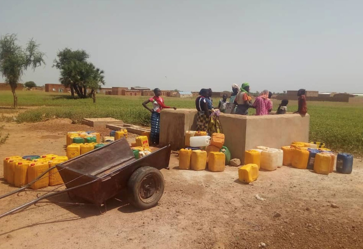 People gathered at an -supported water station near Djibo, in northern Burkina Faso. 