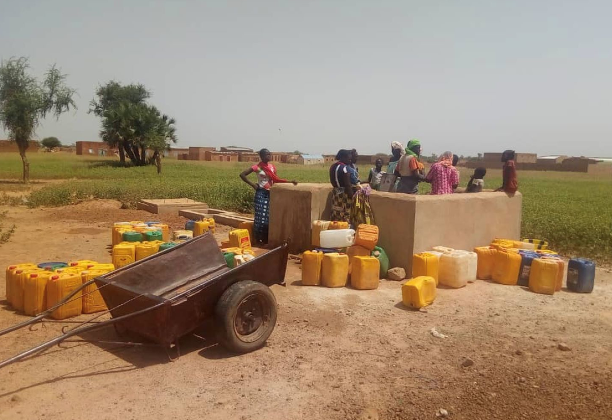 An International Rescue Committee-supported water station near Djibo, in northern Burkina Faso. People gathered at an -supported water station near Djibo, in northern Burkina Faso.