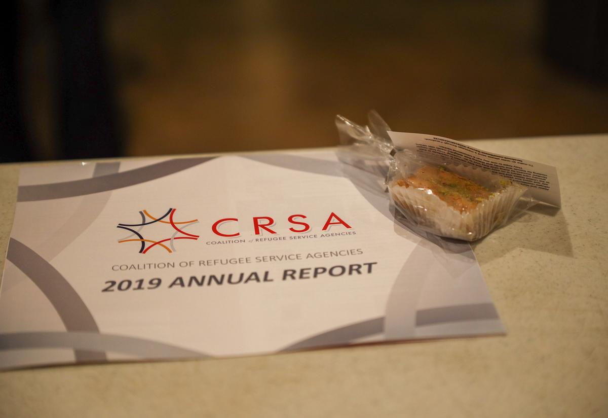 Attendees ensured that the CRSA 2019 Annual Report and a gift of homemade baklava were delivered to all 236 offices in the Georgia General Assembly. A printed copy of the CRSA Annual Report lies on a table next to a small bag of pistachio baklava that was made by a former refugee from Syria.