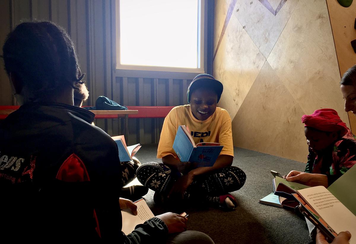 Students reading in groups International Women's Day with Cotopaxi
