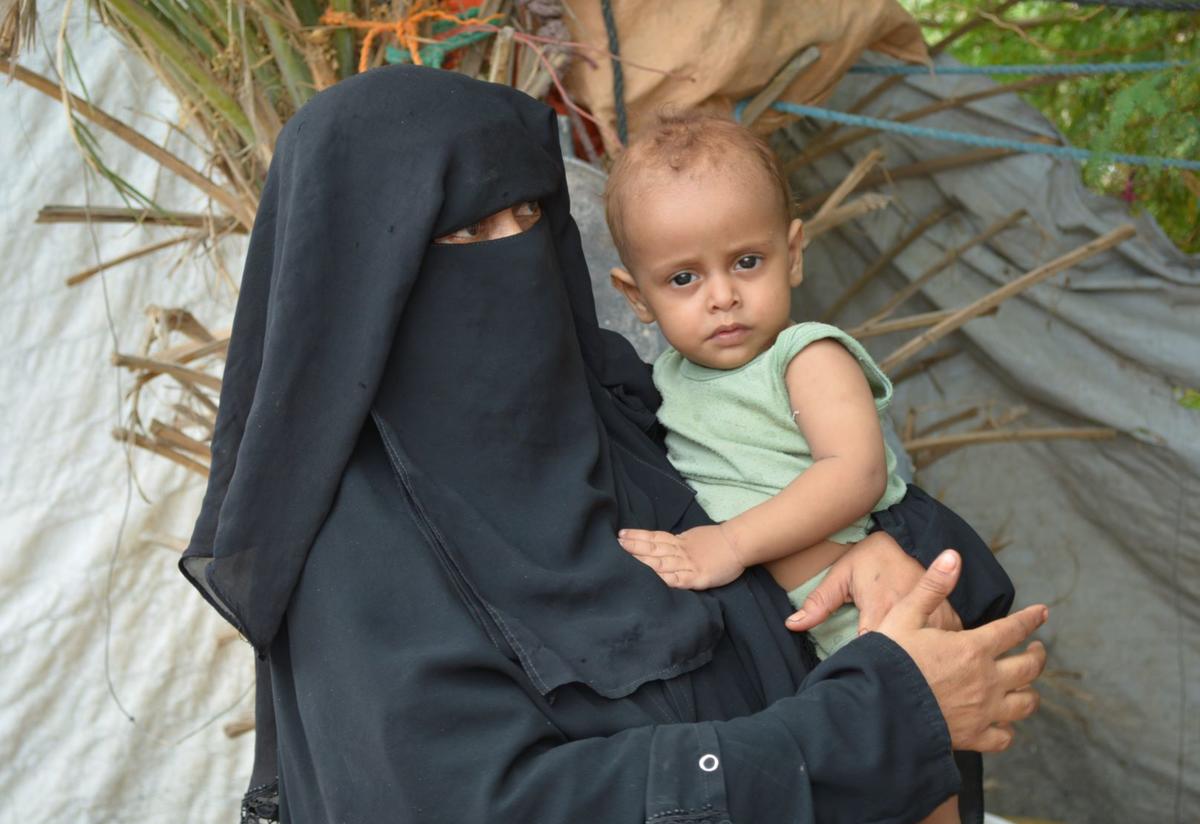 Fathiah Said Saleh Naji, an IRC client, with her child in Aden, Yemen. Fathiah Said Saleh Naji, an IRC client, poses with her child in Aden, Yemen.