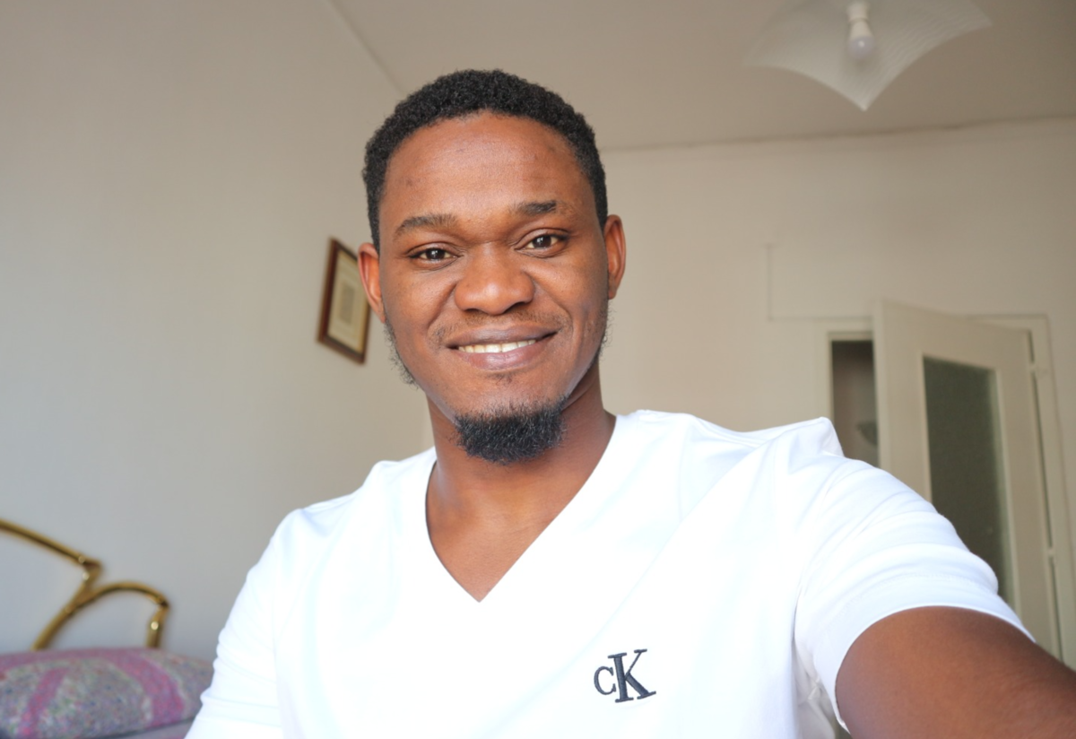 Henry Tbilisi Henry Tbilisi, wearing a white shirt, poses for a selfie in his apartment.