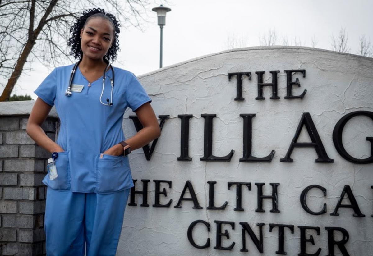Rita Jemimah Bush stands outside her workplace 