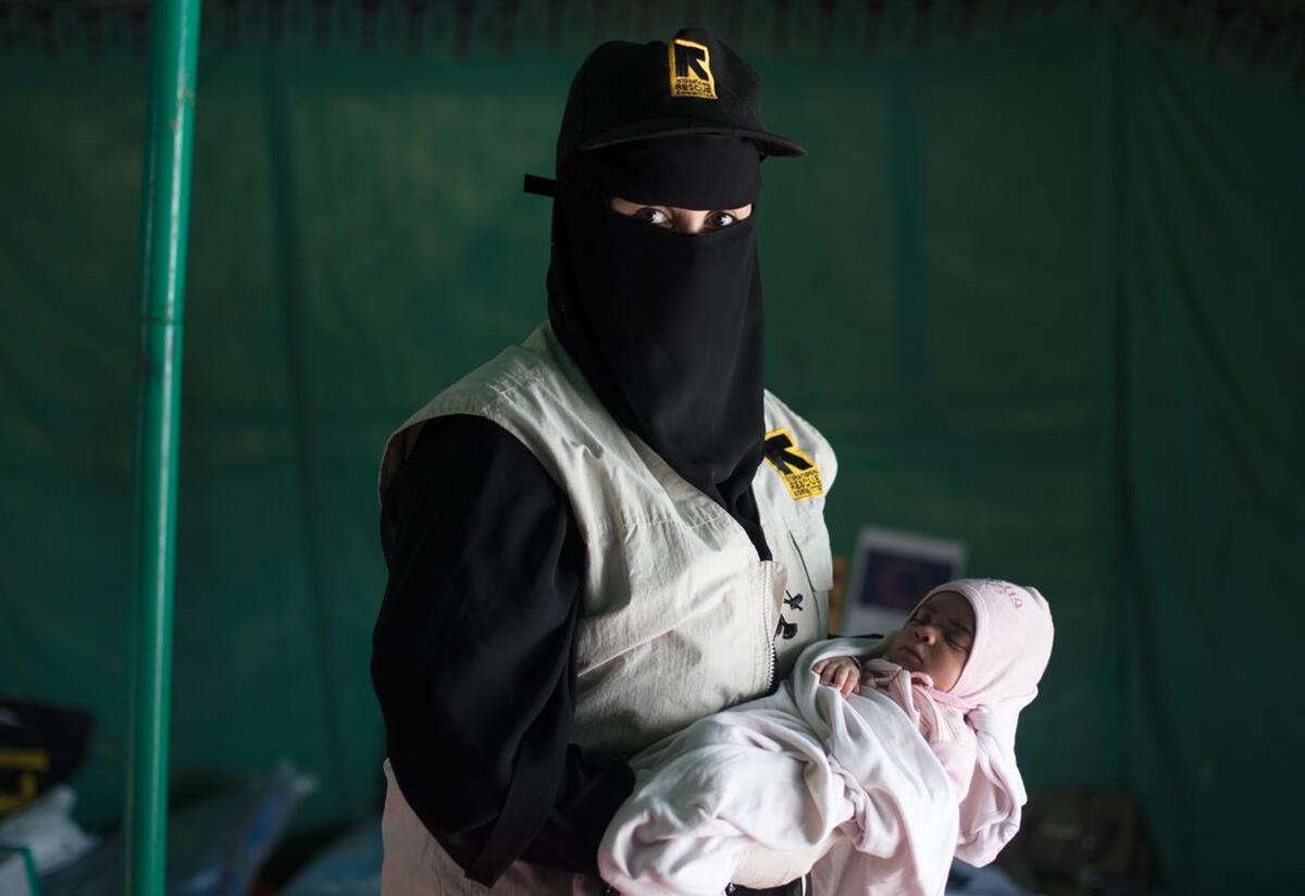Bodor named her daughter Enkath meaning ‘rescue’ in Arabic, as a way of saying thank you to Samya and the IRC. An IRC staff member, wearing an IRC vest, holds Enkath.