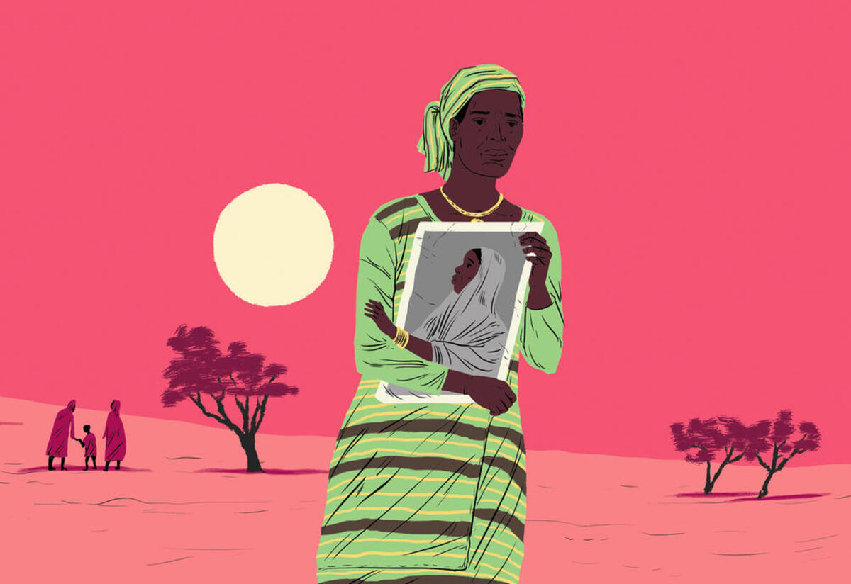 Obioma holds a photo of her children. Obioma, a woman travelling the Central Mediterranean route, holds a photo of her children tight to her chest. She is nearly alone in a barren landscape, with a family of three and two short trees in the distance behind her..