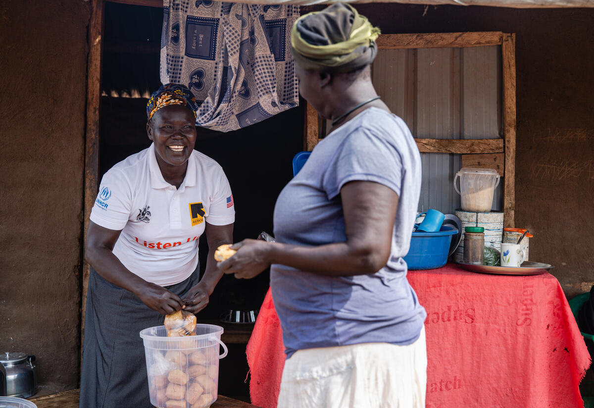 When not doing activist work with Togoleta, Jemimah Sadia runs a small tea and cake shop in the refugee camp where she lives.n Zone II where she bakes short cakes and sells tea. South Sudanese refugee Jemimah Sadia, holding a plastic bag of small cakes, speaks with a customer at her small tea shop in a Ugandan refugee camp.olding a