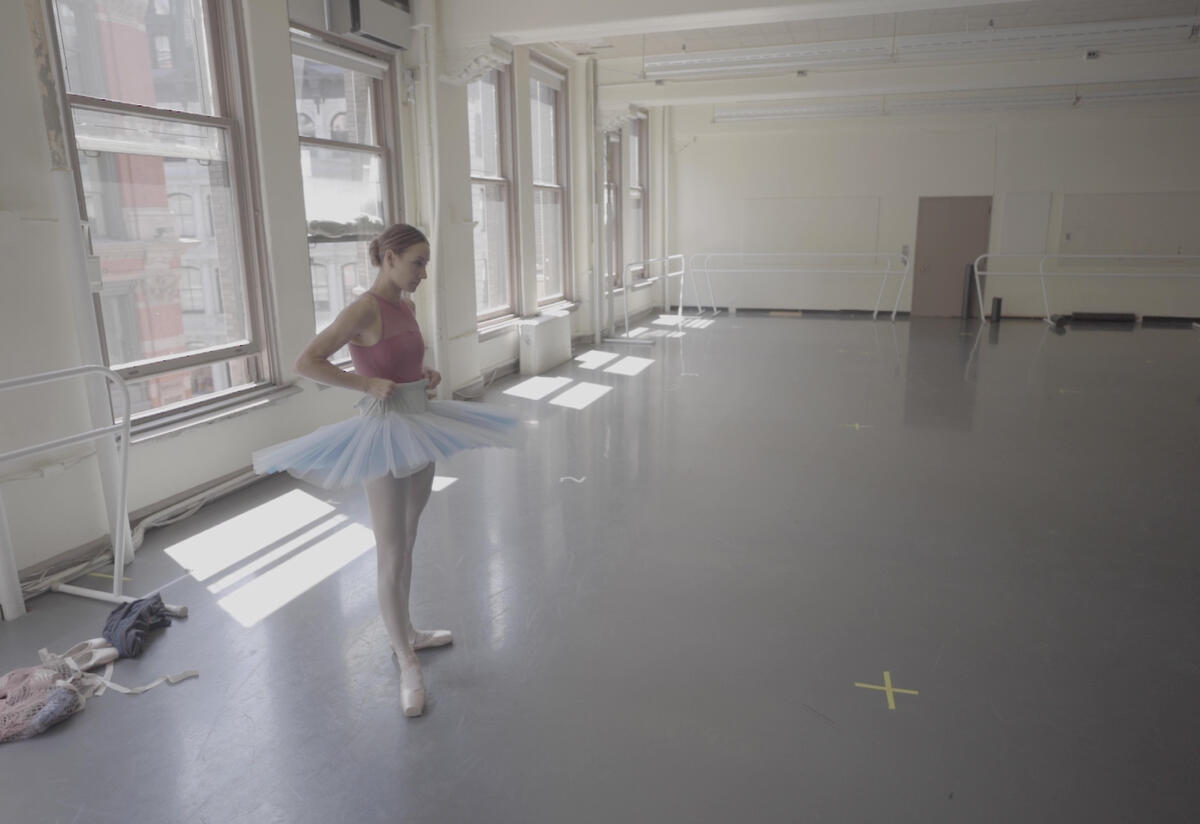Ballerina Christine Shevchenko rehearses Ballerina Christine Shevchenko, wearing a tutu, stands poised to rehearse in a dance studio