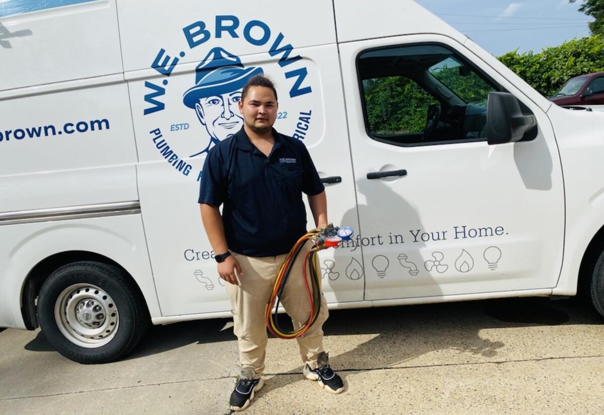 Ali, client, in front of W.E. Brown van Ali in front of W.E. Brown van