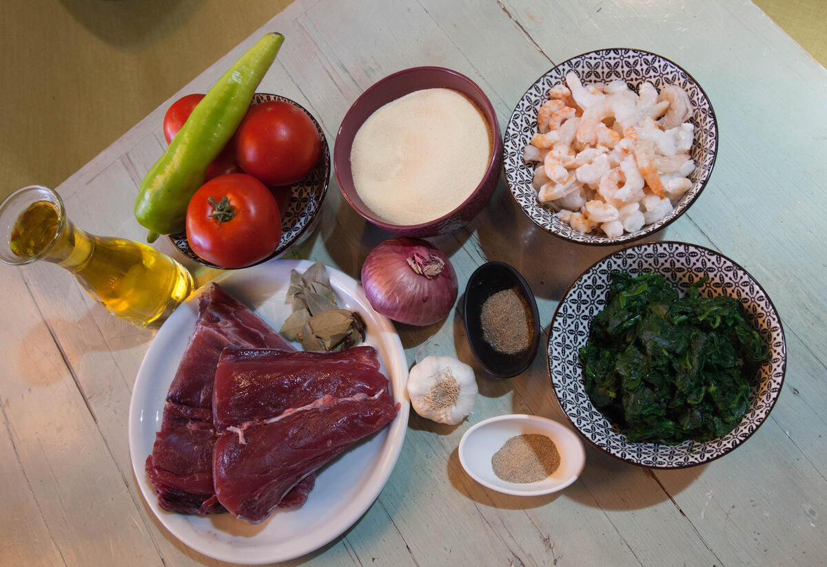 Koteau's spinach and tuna ingredients Raw tuna, tomatoes, spinach, garlic, onions, and other ingredients laid out on a table.