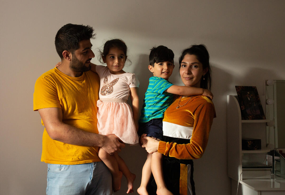 Syrian-Kurdish refugees Maasom and Hiba hold their children Nasrin and Omar.