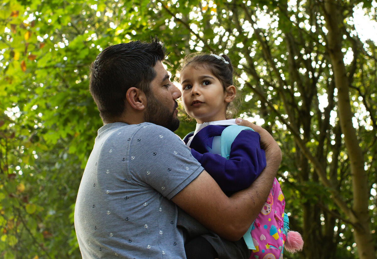 Maasom holds his 4-year-old daughter Nasrin on her first day of preschool.