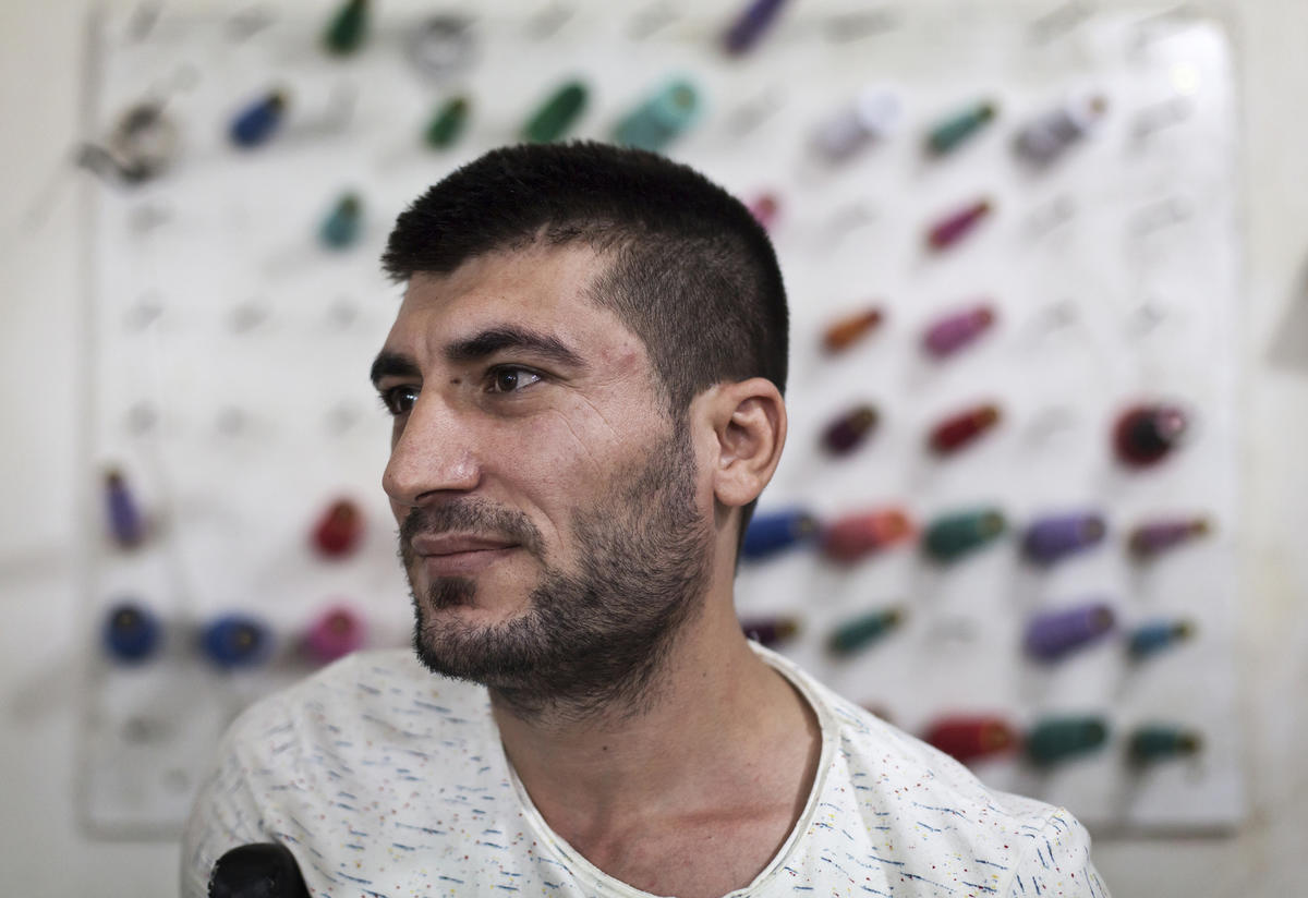 Mohamed Saleh Ismail in May 2016 in the tailoring shop near Beirut where he is an apprentice Mohamed Saleh Ismail stands in front of reels of thread in a tailoring ship near Beirut May 2016