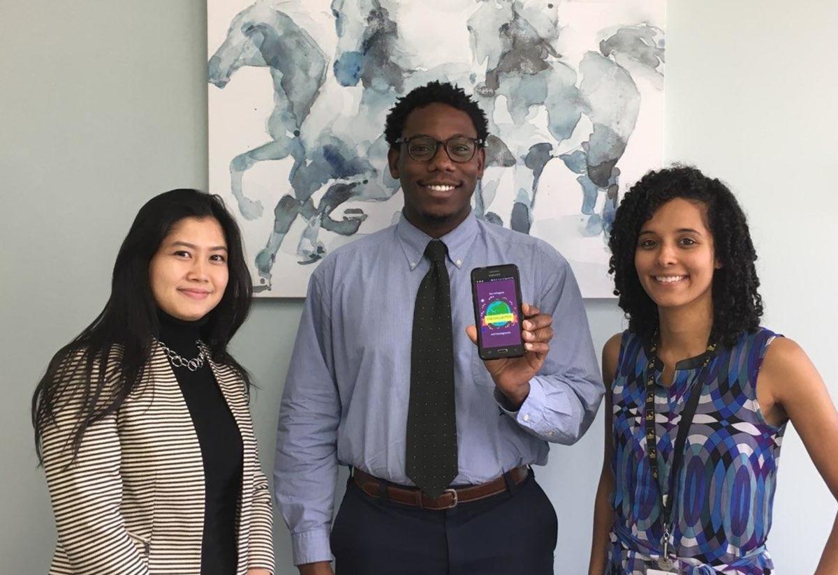 Derek with app collaborators Grace and Shiva Derek Shows off his new Refugee and Immigrant App