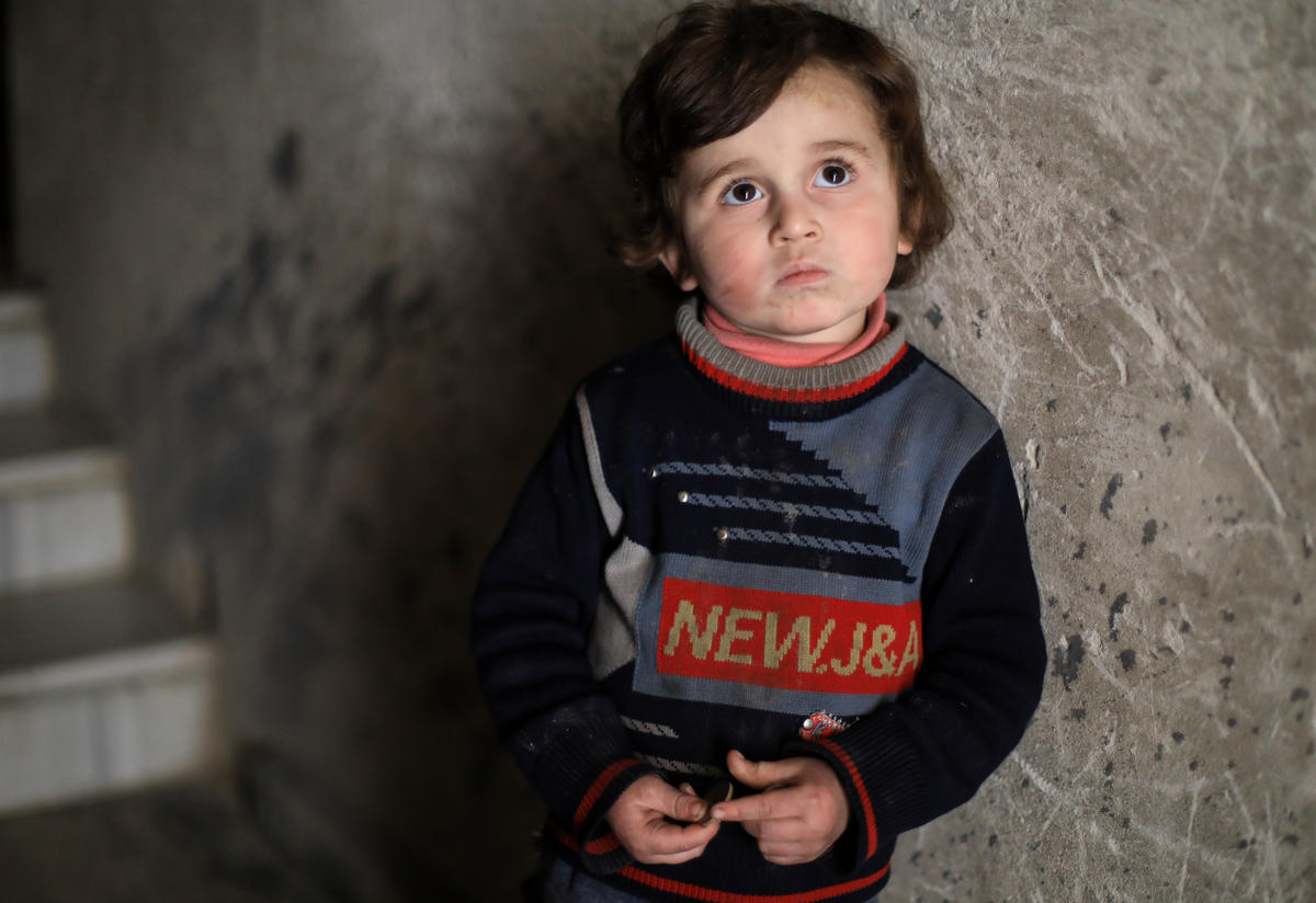 Syrian boy in underground bunker by the stairs Syrian boy in underground bunker by the stairs