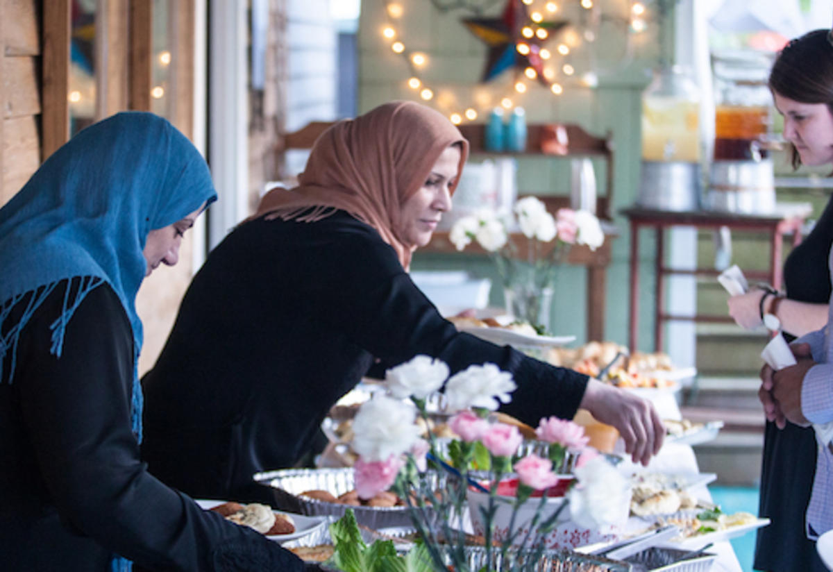 Heba and Nsreen serve dinner.