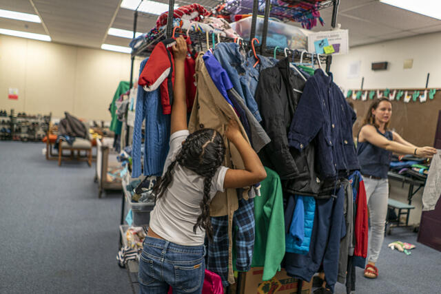 Maria, 7, in the Ropa Room at the IRC Welcome Center in Phoenix, Arizona