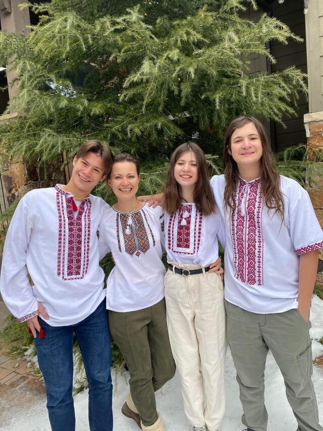 Mother and three kids from Ukraine wearing traditional clothing