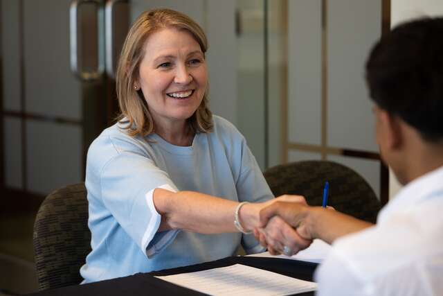A Zions Bank recruiter shakes hands with a refugee youth participant in the IRC in Utah's Future Ready Summer Program.