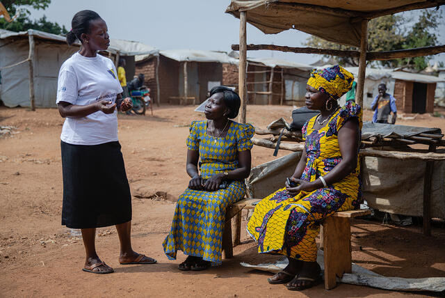 Betty, Grace and Loyce, all members of a refugee women’s activist group, enjoy a chat in Bidi Bidi refugee settlement in Uganda