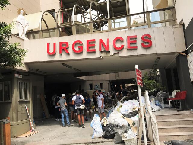 People gather outside a hospital emergency room in Beirut, Lebanon after the explosion