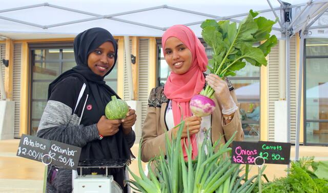 Two Youth Roots summer interns helping out at Namaste Farm Stand in Tukwila 