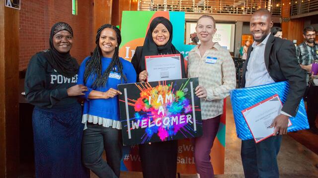 New American entrepreneurs and their supporters at the New American Dream Lab with awards and presents in hand.