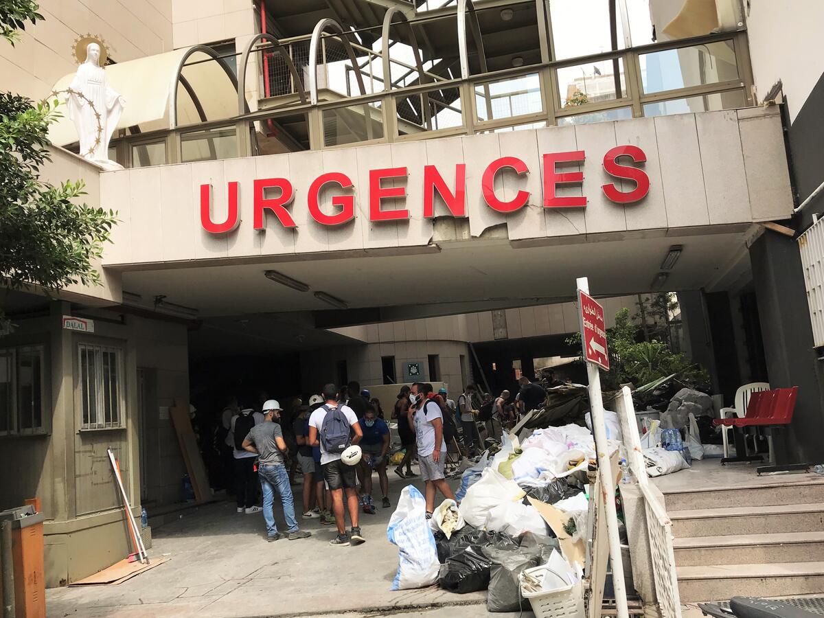 People gather outside a hospital emergency room in Beirut, Lebanon after the explosion