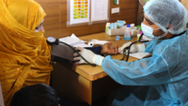 A woman getting her temperature measured in the IRC clinic in Bangladesh.