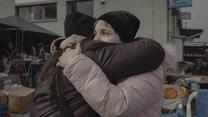 A mother and her daughter meet at the Medyka border crossing point, Poland