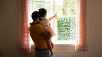 Man and child by window