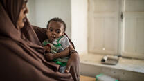 A mother smiles at her child in an IRC malnutrition centre in Somalia