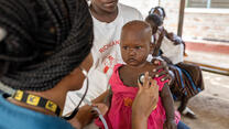 Dr. Sila Monthe, 29, health manager for IRC at Kakuma, checks Vanessa,1, for malnutrition at Locher Angamor Health Dispensary in Kakuma Refugee Camp