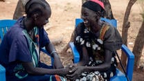 Veronica, 31, talks with her mother, Amou Makuei and support person, in Jamjang, South Sudan