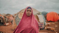 Amina standing facing camera at Torotorow IDP camp