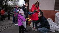 People receiving supplies from IRC workers