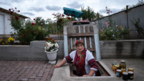 Olga stands halfway in an underground shelter where she stores her pickles.